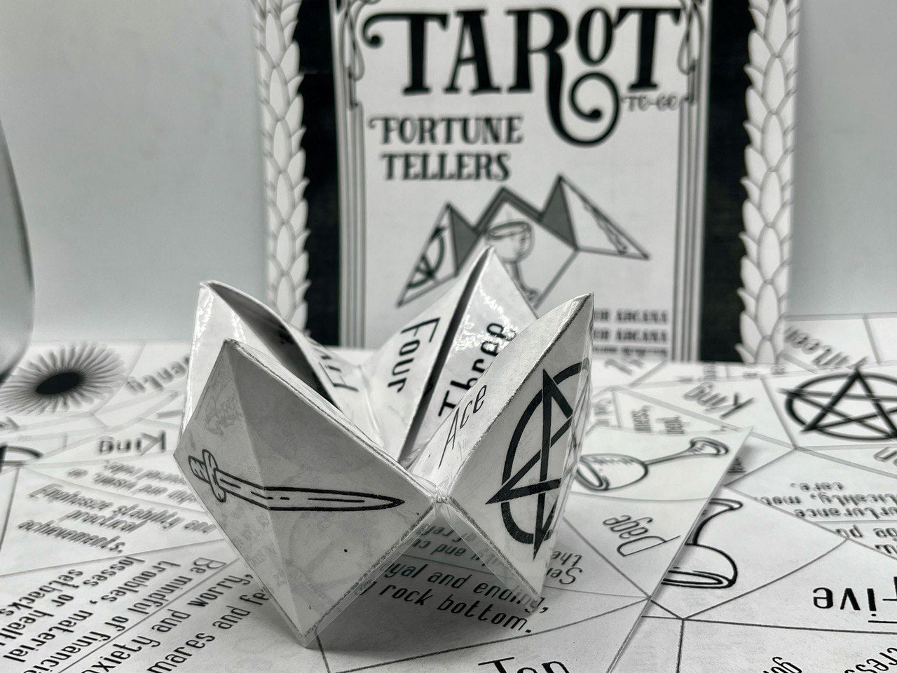 front cover of a pack of eleven tarot themed origami paper sheets with folded fortune teller